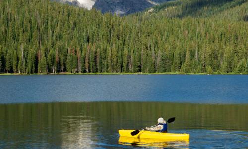 Kayaking on a lake in Rocky Mountain National Park Colorado