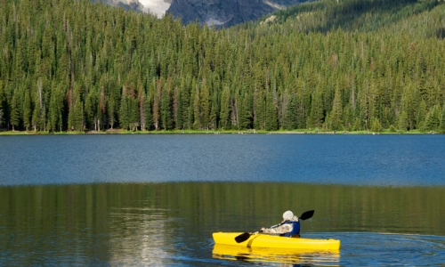 Kayaking on a lake in Rocky Mountain National Park Colorado